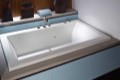 Andrea 14 Bathtub Installed as a Drop-in, Solid Surface Deck