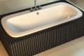 Anora Drop-in Soaker Tub Dropped into a Freestanding Tile Surround