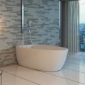 Contura 3 Soaker Tub Installed with Drain Side Against the Wall, with a Wall Mount Tub Filler
