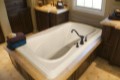 Jennifer Drop-in Bathtub Installed in a Tile and Wood Surround