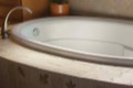 Riley Drop-in Tub Installed, Showing Decorative Rim and Interior Molding