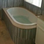 Oval Drop-in tub installed in the corner, glass tile