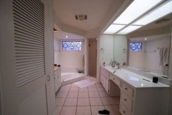 Traditional Bathroom with a recessed tub, long counter and small shower